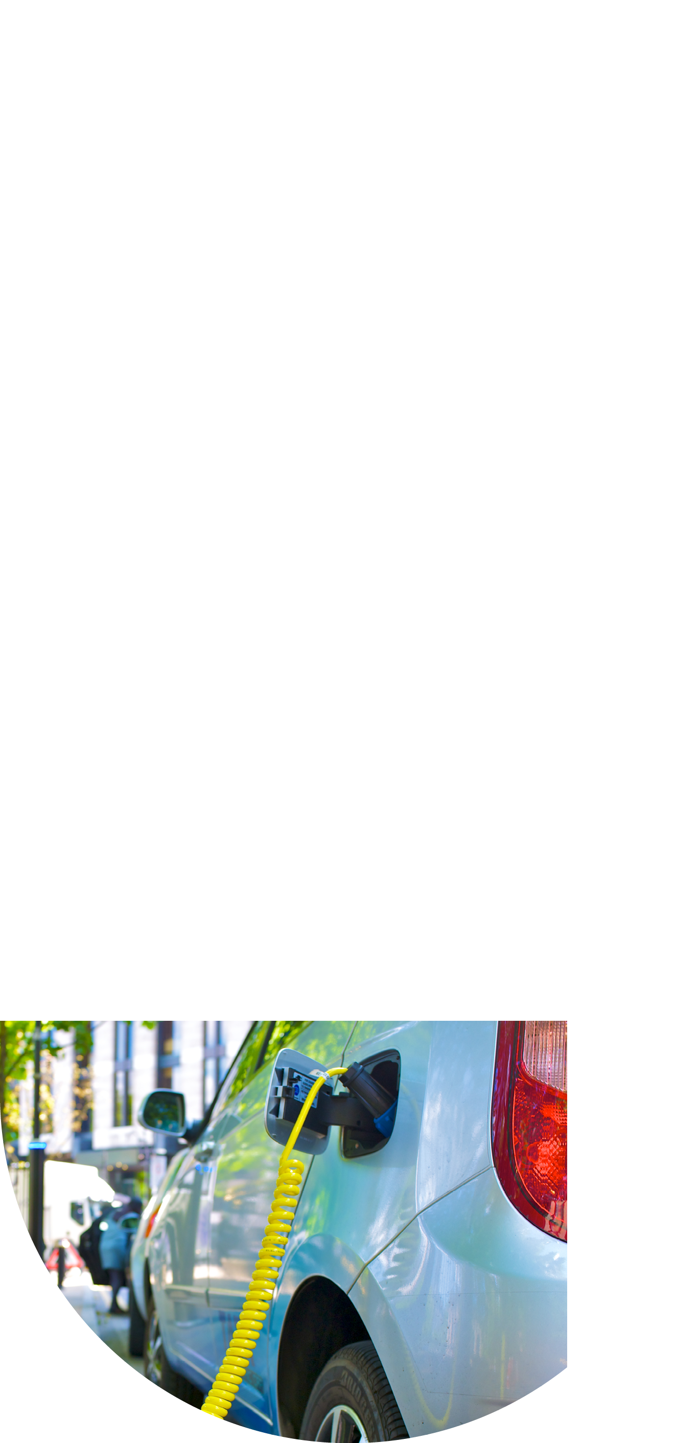 An Eco Electric car is re-charged from city street power point 