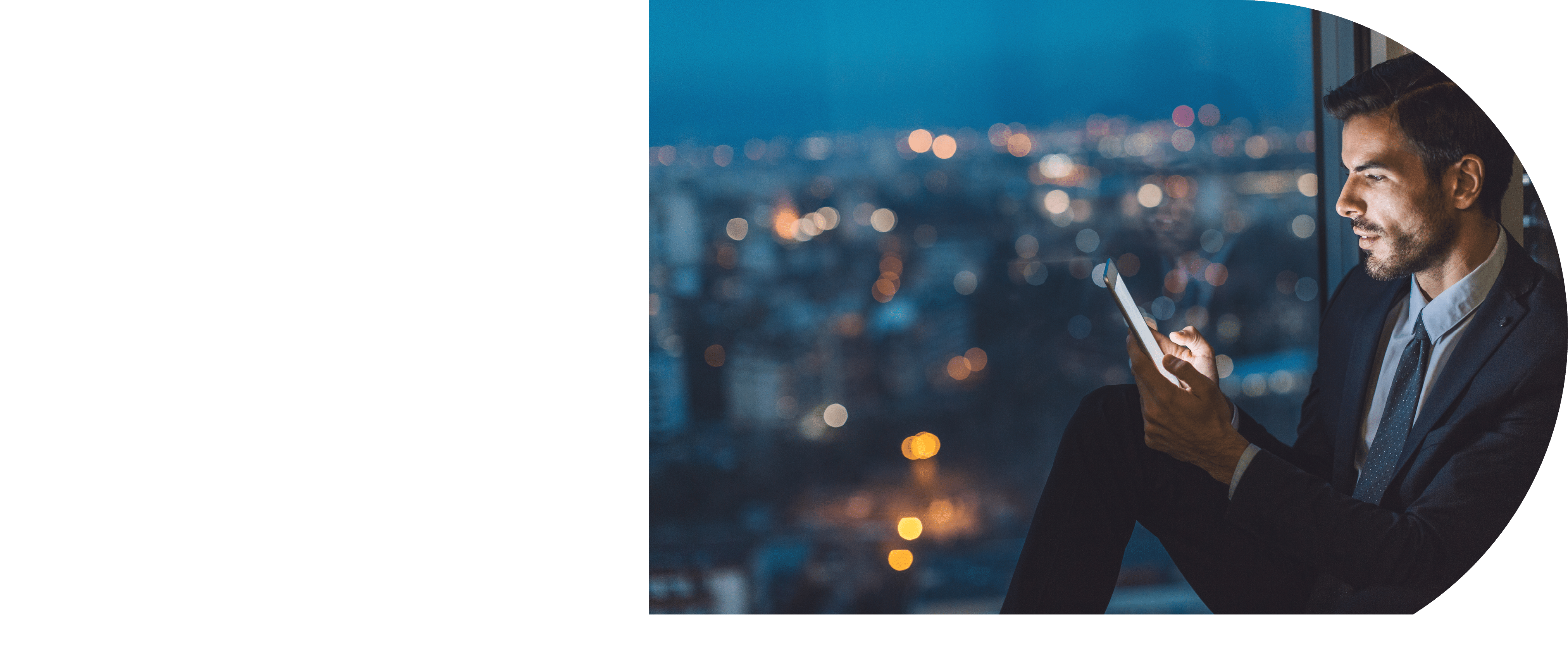 Young businessman with digital tablet in the office in the evening
